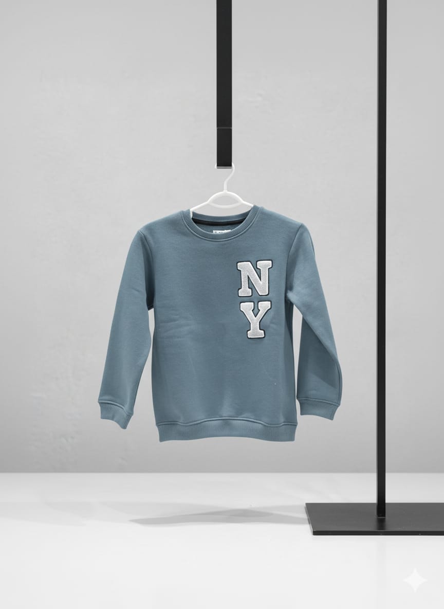 Blue sweatshirt with 'NY' on a hanger against a gray background